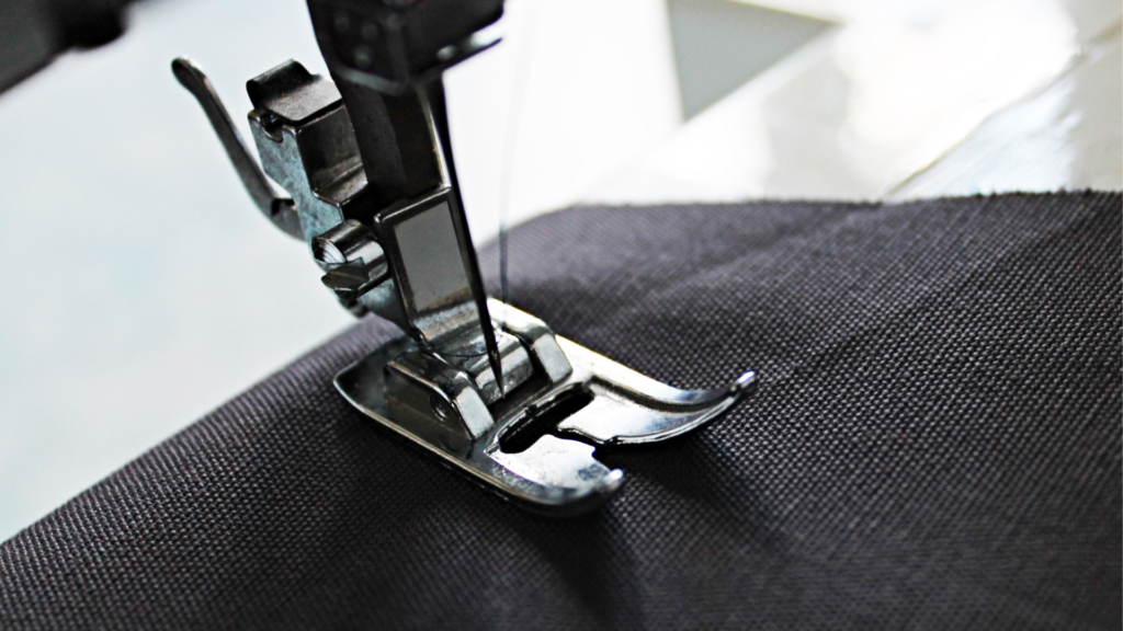 Sewing machine needle stuck in a down position on a fabric