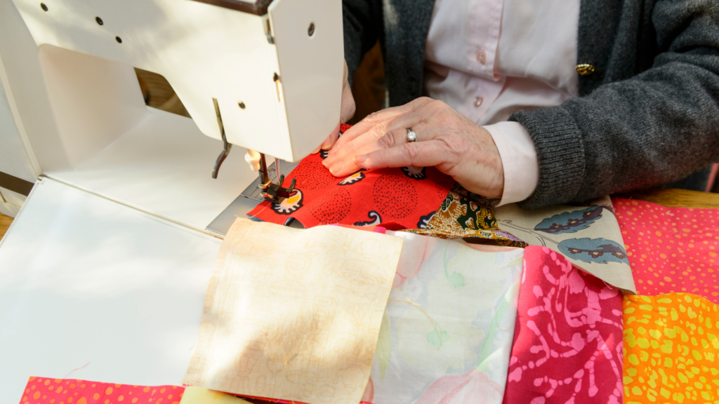 A woman quilting with a sewing machine